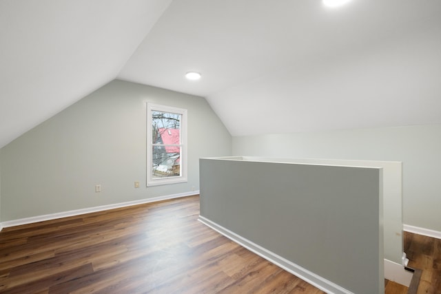 bonus room featuring dark hardwood / wood-style flooring and vaulted ceiling