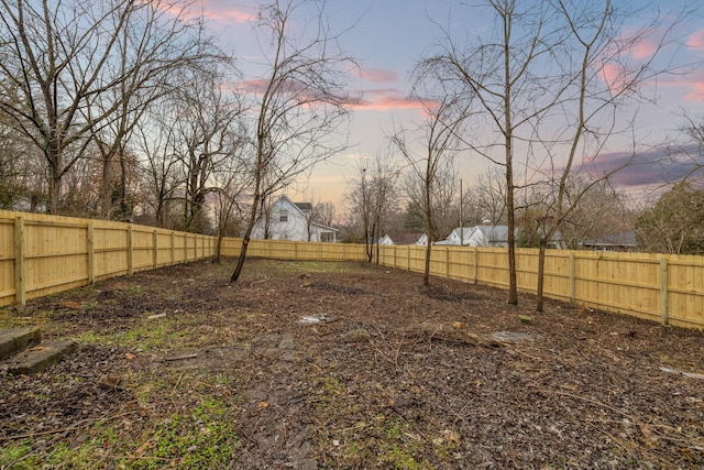 view of yard at dusk