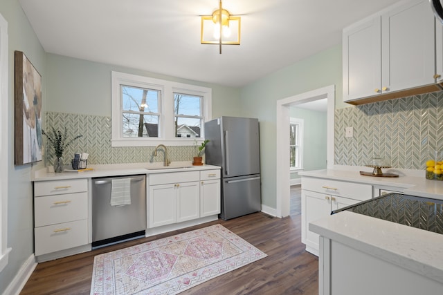 kitchen featuring dark wood-type flooring, sink, white cabinetry, and appliances with stainless steel finishes