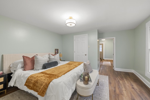 bedroom with dark hardwood / wood-style flooring