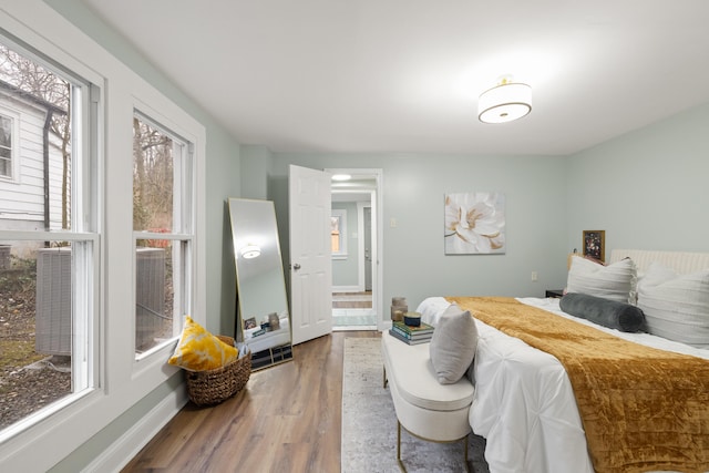 bedroom featuring hardwood / wood-style flooring and multiple windows