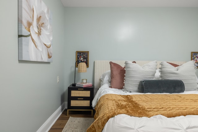 bedroom with dark wood-type flooring