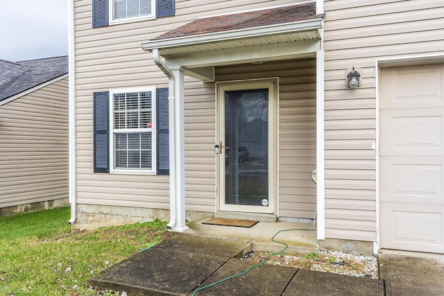 doorway to property with a garage