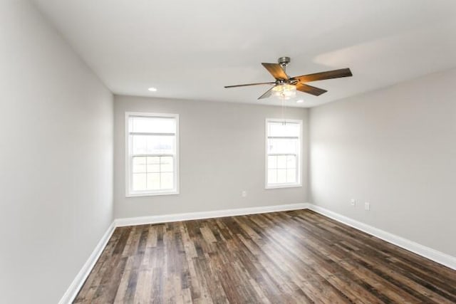 spare room with dark hardwood / wood-style floors and ceiling fan