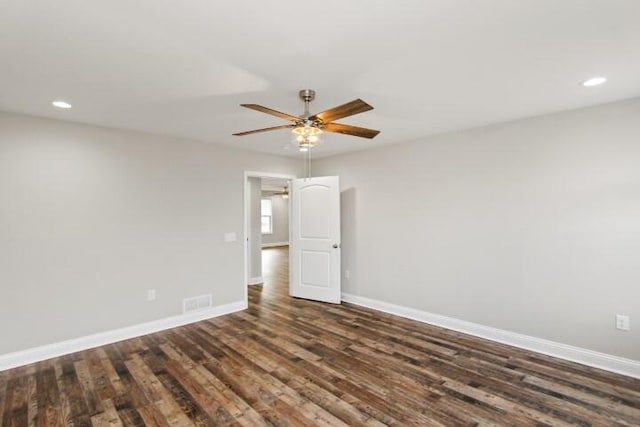 empty room featuring ceiling fan and dark hardwood / wood-style flooring