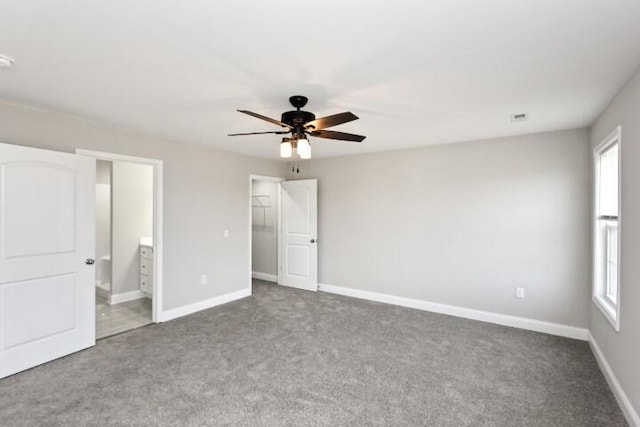 unfurnished bedroom with connected bathroom, ceiling fan, and carpet floors