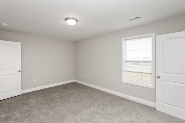 carpeted empty room featuring plenty of natural light