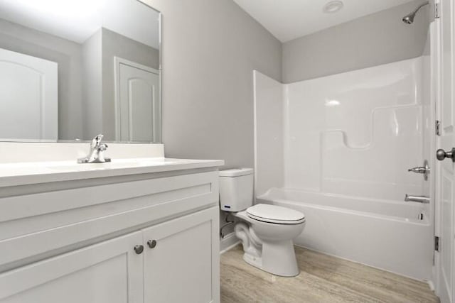 full bathroom featuring shower / bath combination, vanity, toilet, and wood-type flooring