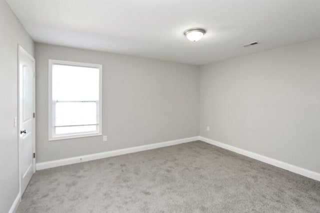 carpeted empty room featuring a healthy amount of sunlight