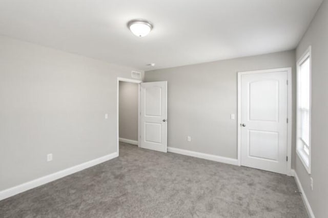 unfurnished bedroom featuring light carpet