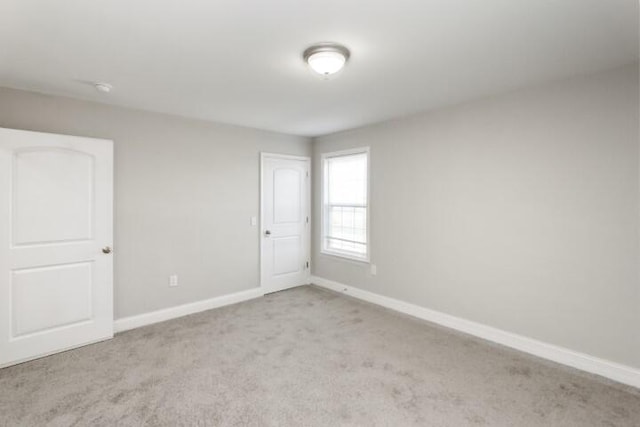 spare room with light carpet