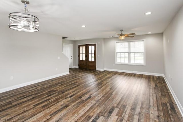 interior space featuring french doors, ceiling fan with notable chandelier, and dark hardwood / wood-style flooring