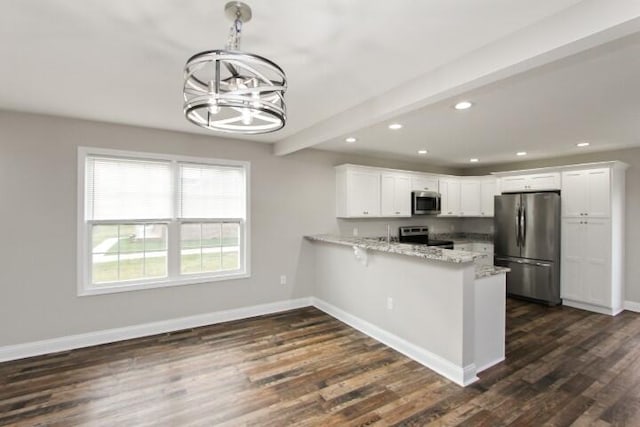 kitchen with white cabinetry, stainless steel appliances, beamed ceiling, a notable chandelier, and kitchen peninsula