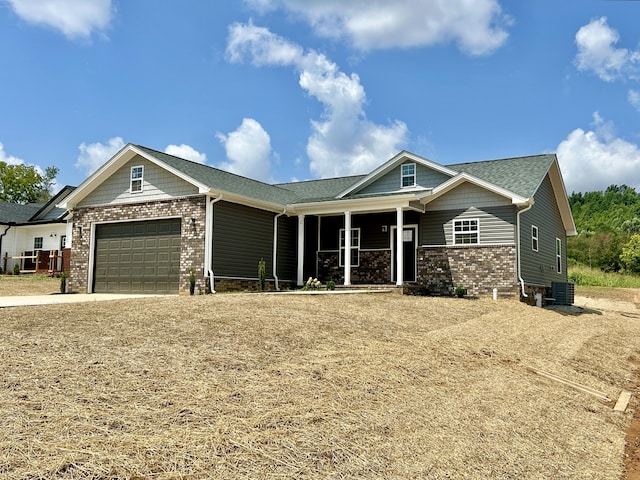 craftsman-style home featuring a garage and central AC