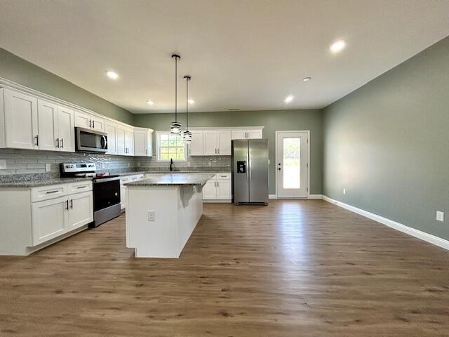 kitchen featuring white cabinets, a center island, and stainless steel appliances