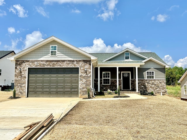 view of front facade featuring covered porch, a garage, and cooling unit