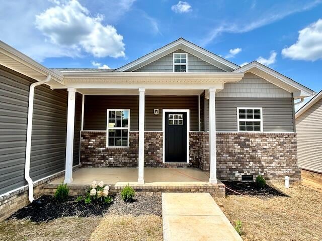 property entrance featuring covered porch