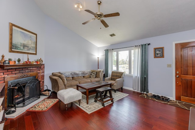 living room with ceiling fan, a fireplace, wood-type flooring, and vaulted ceiling