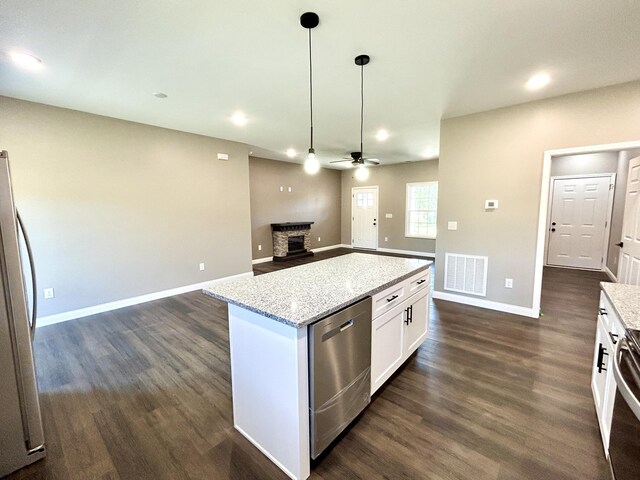 kitchen with white cabinetry, dishwasher, ceiling fan, refrigerator, and decorative light fixtures