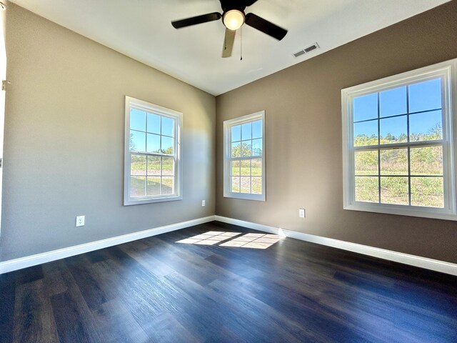 spare room featuring ceiling fan and dark wood-type flooring