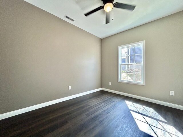 empty room featuring ceiling fan and dark hardwood / wood-style floors