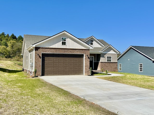 view of front of home with a front yard and a garage