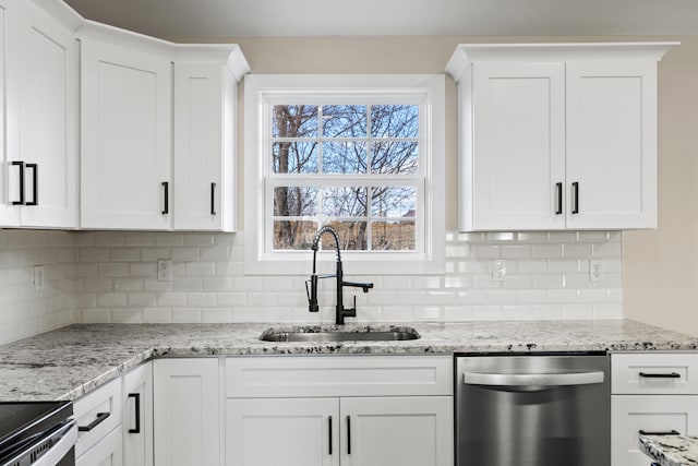 kitchen with sink, light stone countertops, white cabinets, and dishwasher