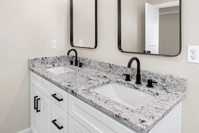 full bathroom featuring a sink and double vanity