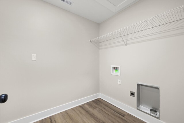 washroom featuring hardwood / wood-style flooring, washer hookup, and electric dryer hookup