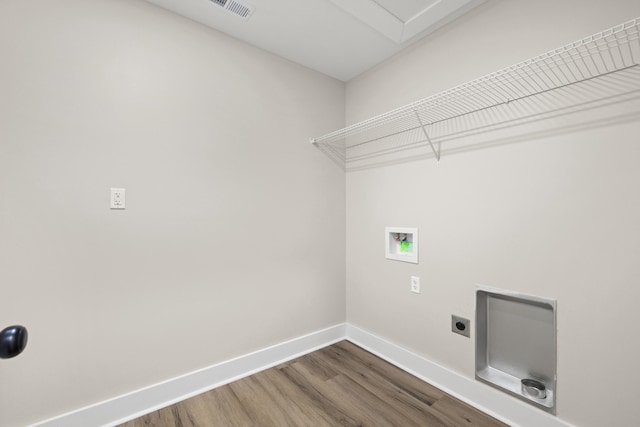 laundry area featuring visible vents, electric dryer hookup, wood finished floors, laundry area, and baseboards