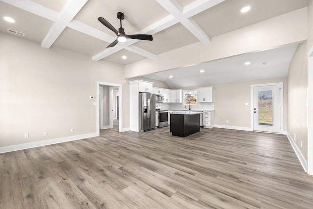 unfurnished living room with beam ceiling, ceiling fan, coffered ceiling, and light hardwood / wood-style floors