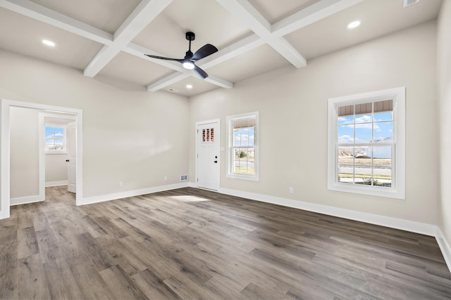 unfurnished room with a healthy amount of sunlight, baseboards, coffered ceiling, and wood finished floors