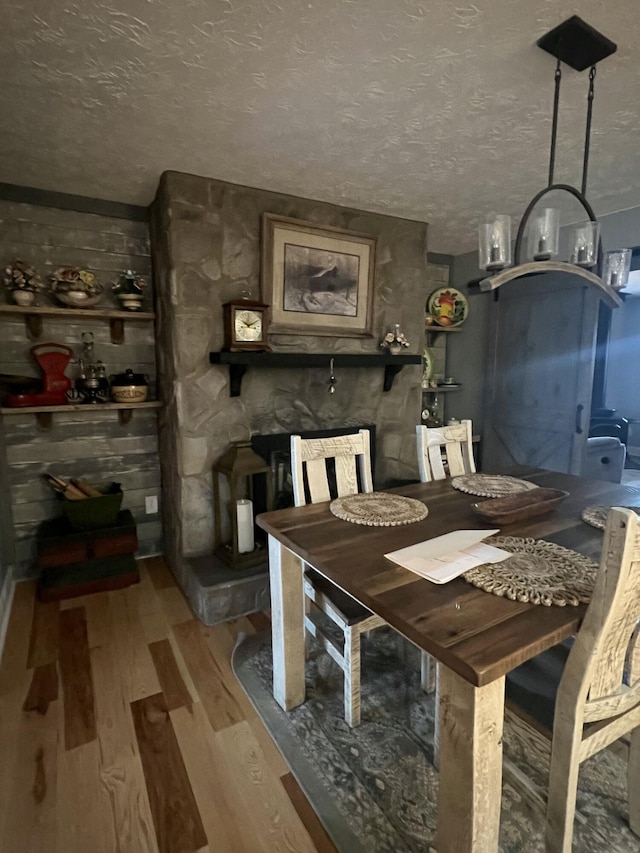 unfurnished dining area featuring a textured ceiling and light wood-type flooring