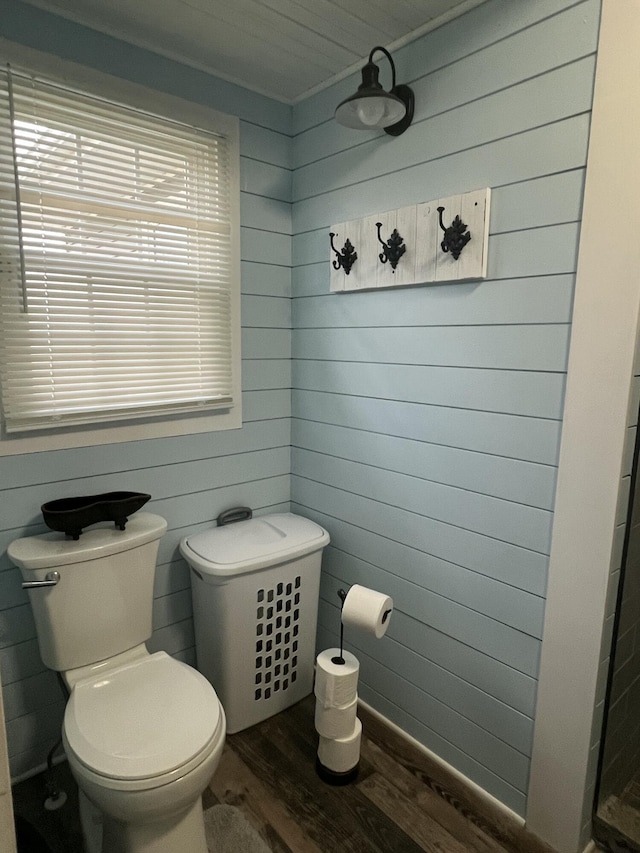 bathroom with toilet and hardwood / wood-style flooring