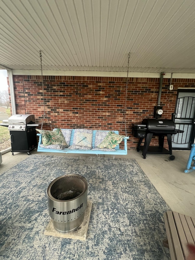 view of patio / terrace featuring area for grilling and a fire pit