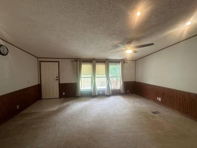 carpeted spare room with ceiling fan and a textured ceiling