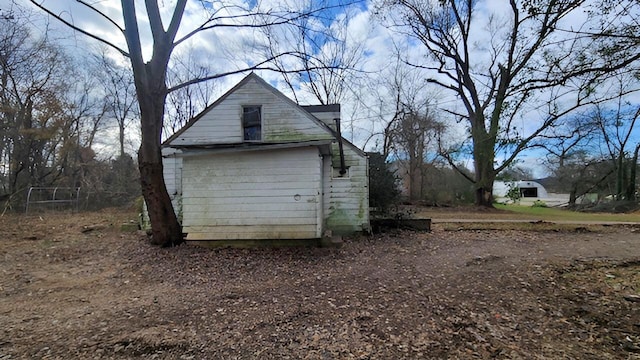 view of property exterior with an outbuilding