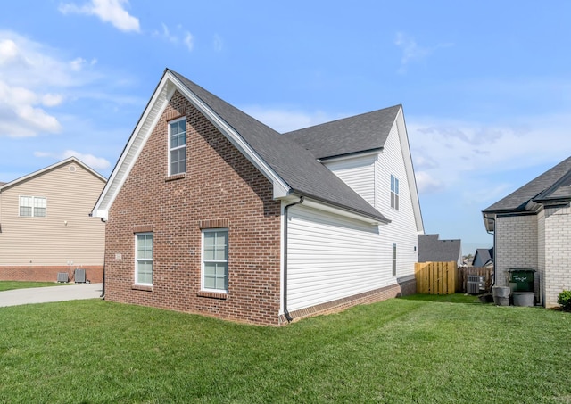 view of home's exterior featuring central AC and a lawn