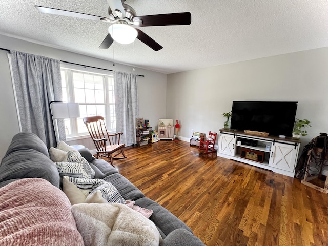 living room featuring ceiling fan, wood-type flooring, and a textured ceiling