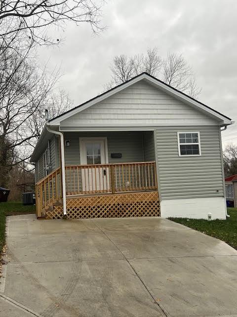 view of front facade with cooling unit and a porch