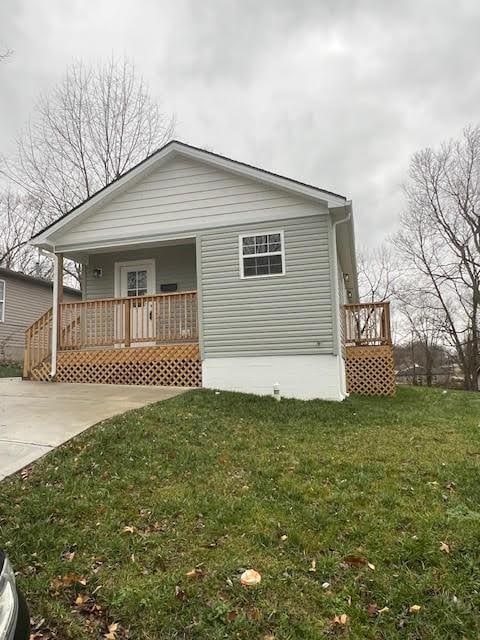 exterior space featuring a lawn and a porch