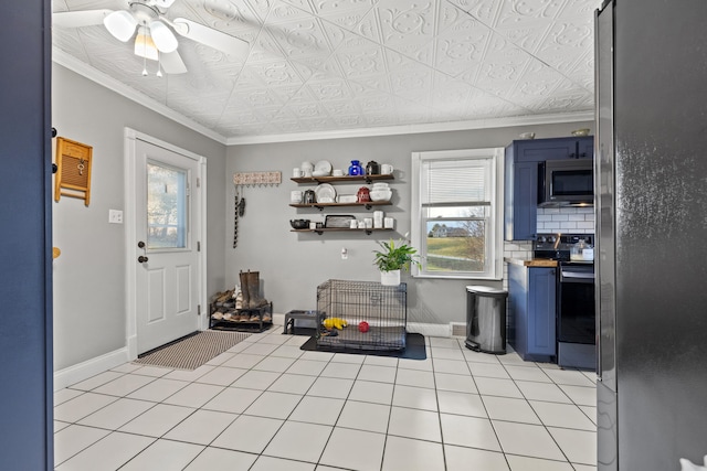 interior space with ceiling fan and crown molding