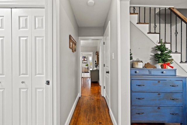 corridor with dark hardwood / wood-style flooring