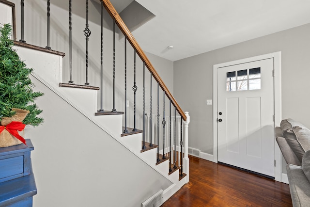 entryway with dark hardwood / wood-style flooring