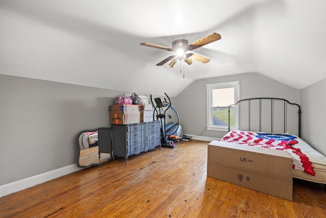 bedroom with ceiling fan, light wood-type flooring, and lofted ceiling