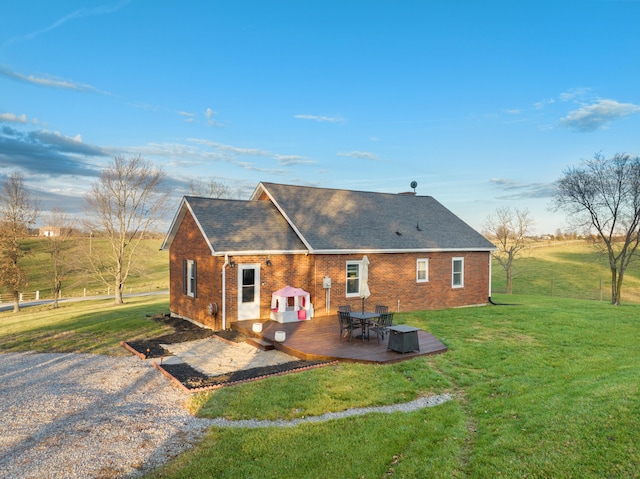 back of property with a yard and a patio