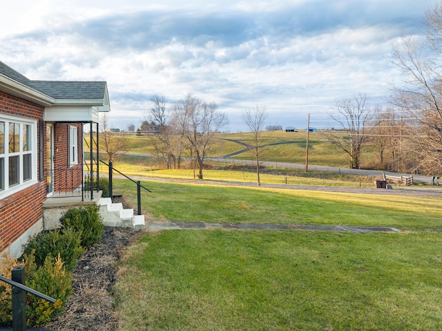 view of yard with a rural view