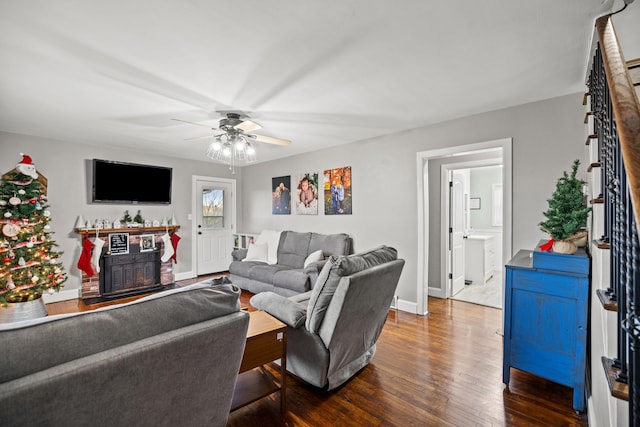 living room featuring ceiling fan and hardwood / wood-style flooring