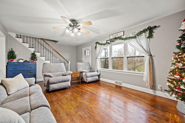 living room with ceiling fan and dark wood-type flooring