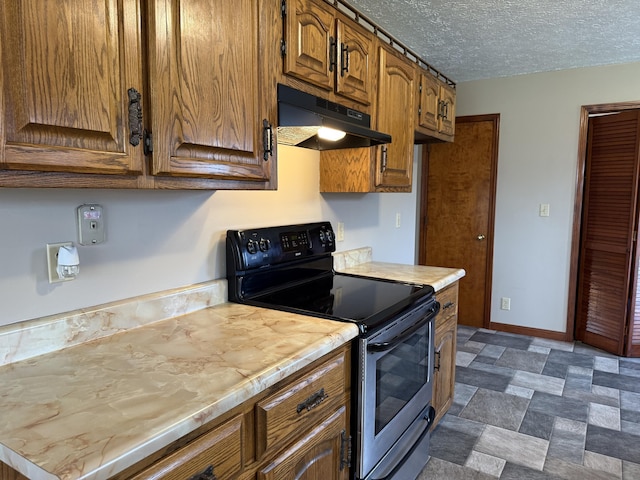 kitchen featuring a textured ceiling and black range with electric stovetop